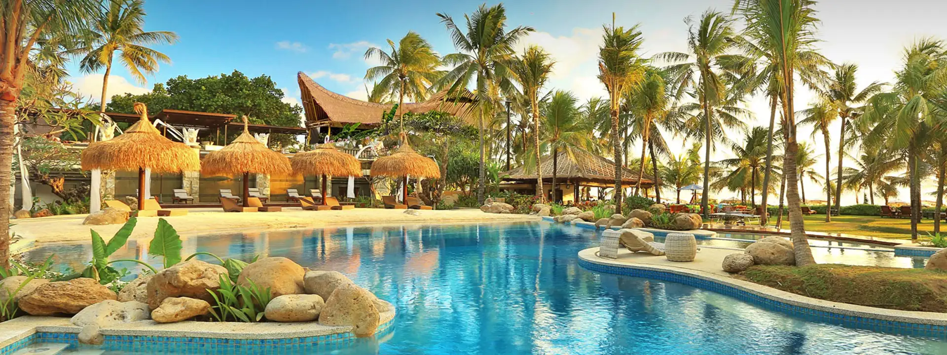BALI-MANDIRA-BEACH-HOLIDAY-PACKAGE-slider-palms-at-the-pool