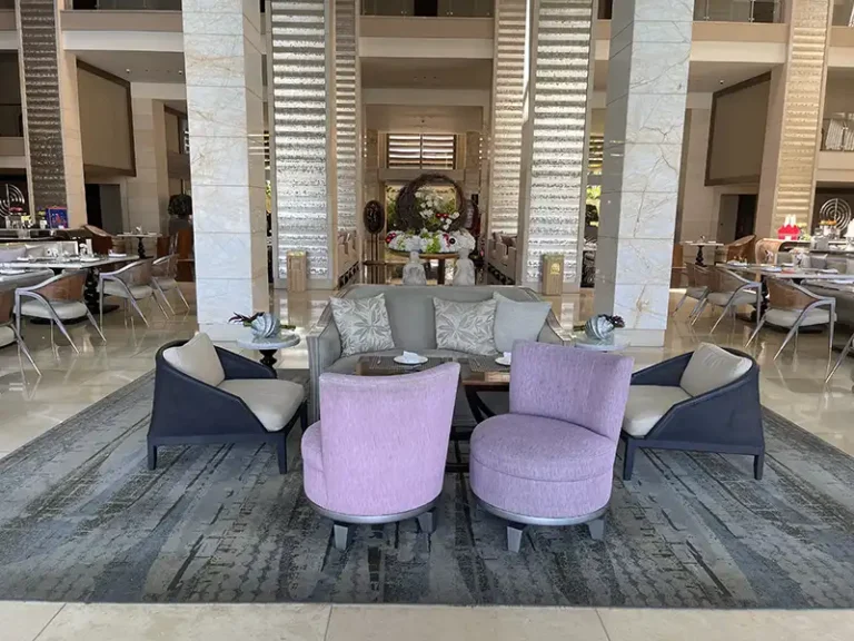 MULIA coffee table and mauve tub chairs